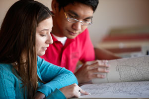 Two peer coaches reviewing historical materials