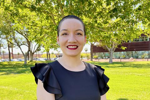 Woman standing outside by tree