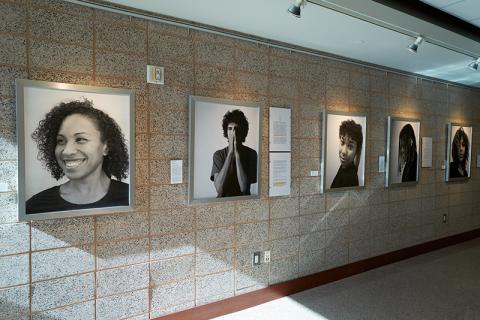 Wall with framed, black and photographs