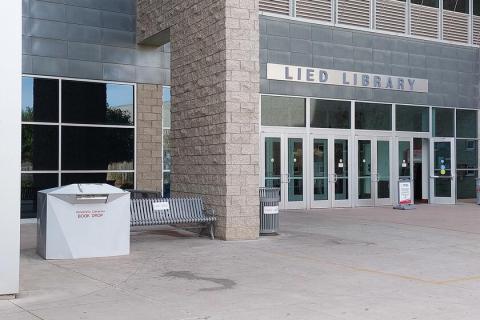 Large white library drop box located at the east (main) entrance to Lied Library.