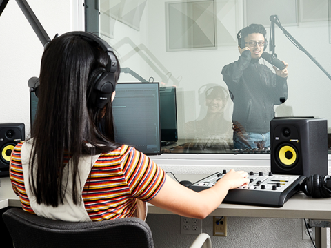 Students using multimedia equipment in production room.