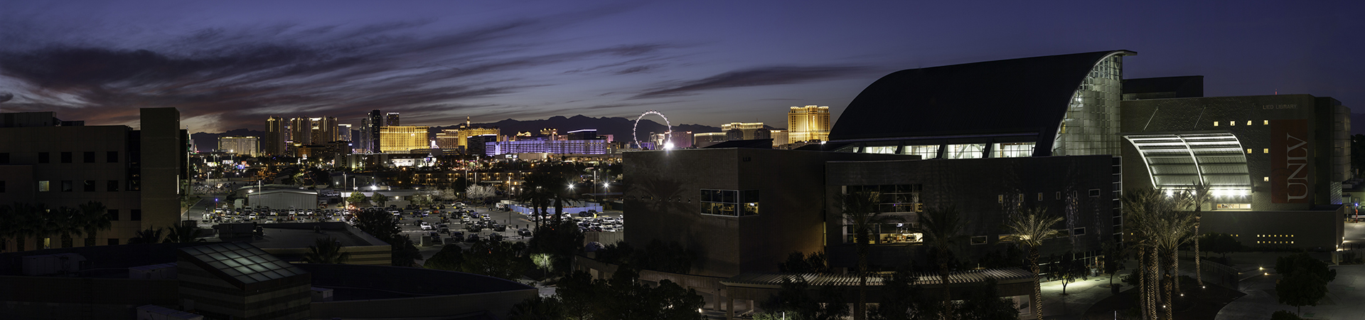 Night view of Lied Library with Las Vegas Strip lit up in background
