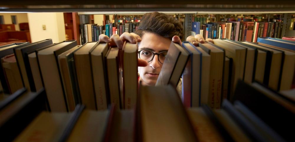 Salvatore Veltre III browsing the stacks in UNLV University Libraries, 2016