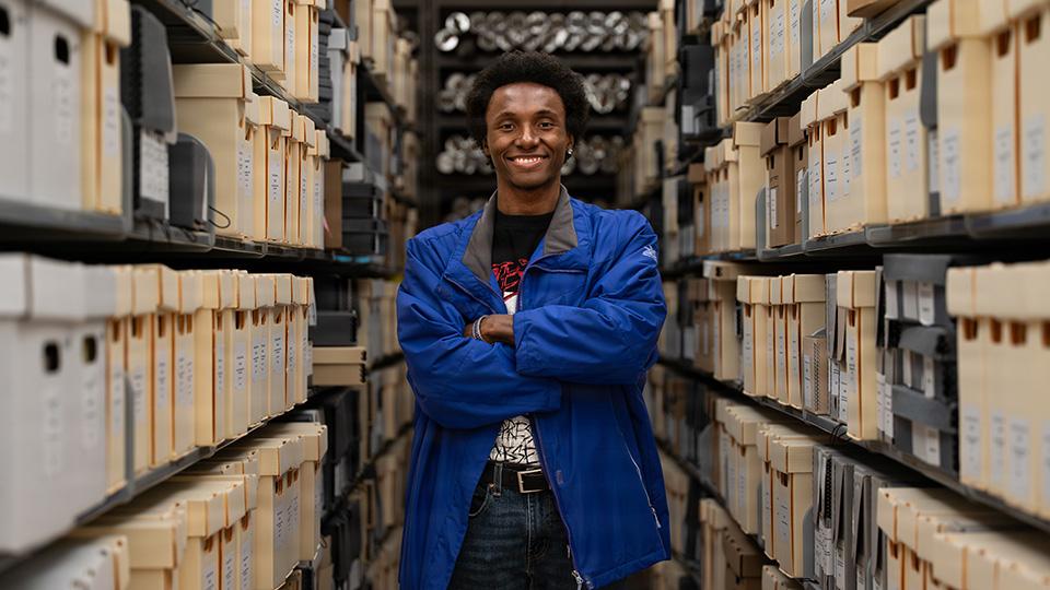 Nellis AFB, UNLV collaborate on preserving the base’s history Malik Ahmad, a digital collections student assistant with the University of Nevada, Las Vegas, stands for a photo at the UNLV Lied Library in Las Vegas, Nevada, April 21, 2026. Ahmad is leading the digitization of more than 50,000 Nellis Air Force Base newspapers.