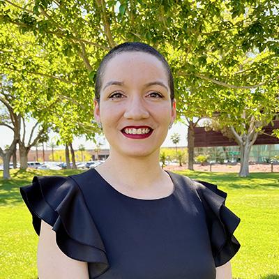 Woman standing outside by tree