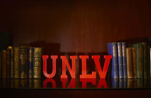 UNLV letters between books on a bookshelf