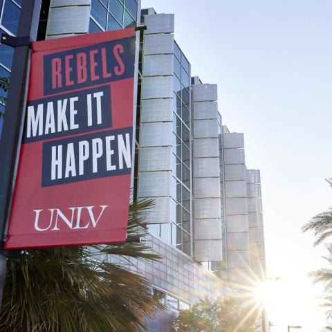 Exterior of Lied Library with Rebels Make It Happen banner hanging on a light pole