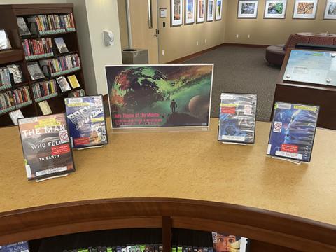 Science Fiction themed books and movies display on a shelf