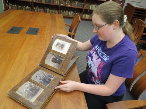 Kayla McDuffie displays photos from the Leonard Blood Papers