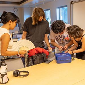 A group of students races to solve clues in the escape room.