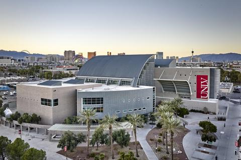 Lied Library, a modern building with a curved roof and city skyline in the background.