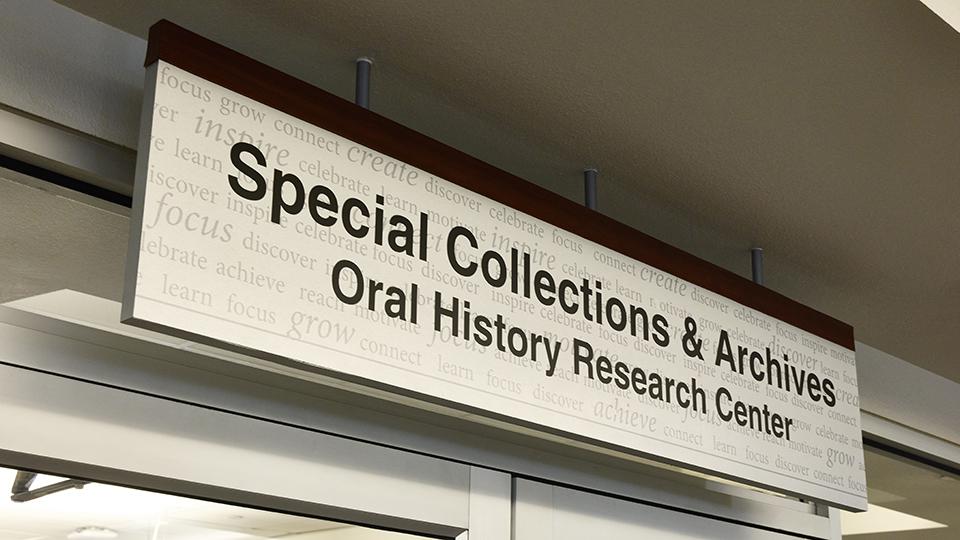 Sign reading "Special Collections & Archives Oral History Research Center" with a textured background.