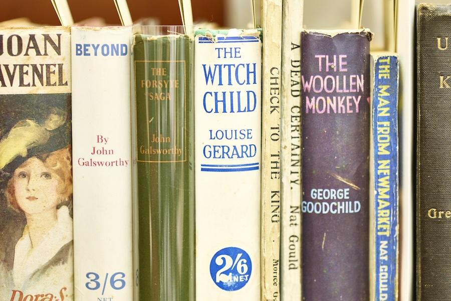 Close-up of vintage books on a shelf with varied titles and colors.