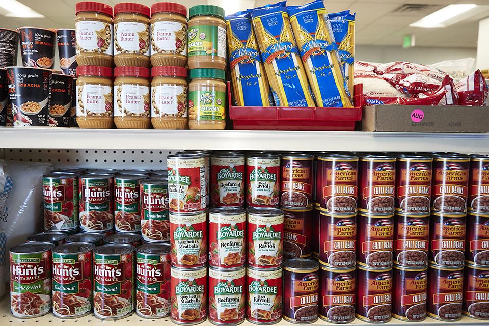 Stacks of canned food on the shelves at the UNLV Food Pantry.