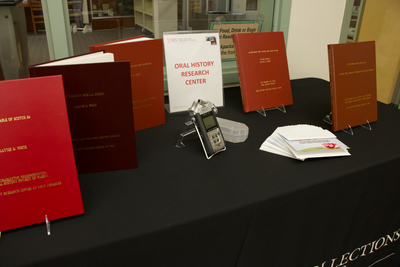 Display of bound oral histories and a recorder used in conducting oral histories. 