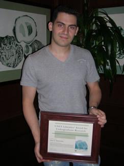 Alexi K. Nedeltchev holding award certificate