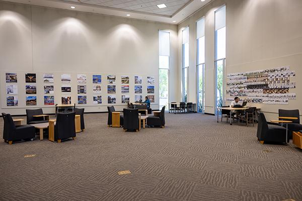 Large gallery space on the library's first floor with high ceilings and tall windows.