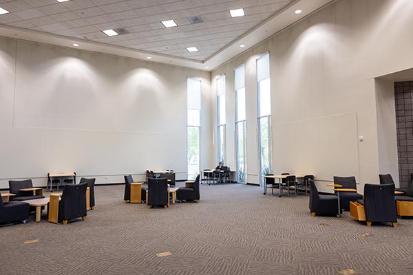 Large gallery space on the library's first floor with high ceilings and tall windows.