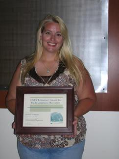 Christina L. Dykstra holding award certificate