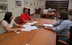 Director of Special Collections sitting at table meeting with two members of the Huntridge Foundation Board.