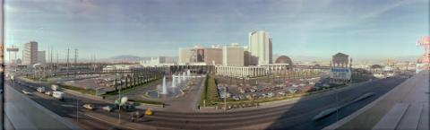 The exterior of the Caesars Palace in Las Vegas, Nevada. The casino is seen from across Las Vegas Boulevard with a parking lot and water fountains in the foreground. An anniversary banner showing a side-by-side portrait of a young Frank Sinatra and an older Frank Sinatra hangs on the side of the casino.