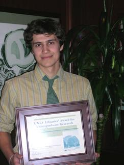 Jacob T. Smigel holding award certificate