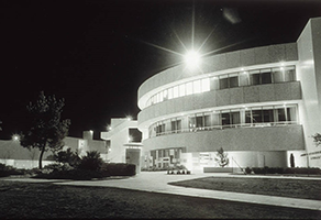 Black and white nighttime photo of James R. Dickinson Library