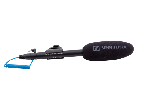 Black Sennheiser shotgun microphone with a foam windscreen connected to a black shock mount and a blue TRS cable.