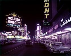 Fremont Street at night with many lit neon signs