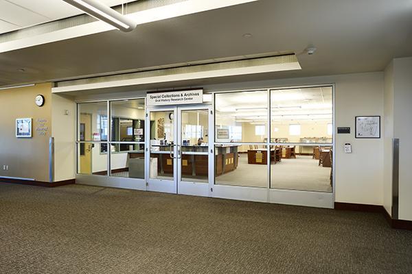 Entrance to the Special Collections & Archives with glass doors and visible interior desks and bookshelves.