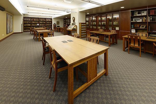 The interior reading room in Special Collections with wooden tables, chairs, and bookshelves.