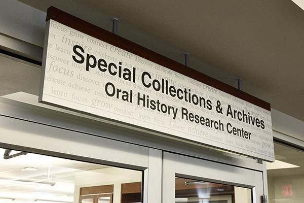 Sign reading "Special Collections & Archives, Oral History Research Center" above glass doors.