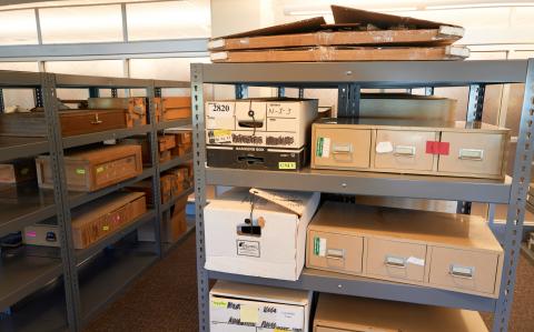 Airplanes and other collection artifacts in the grant project workspace in Lied Library, ready for the team to process and rehouse. 