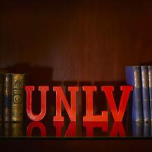 UNLV letters between books on a bookshelf