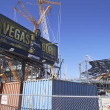 A billboard advertising the Vegas Golden Knights Hockey team looms over the Allegiant Stadium construction site on May 29, 2019.
