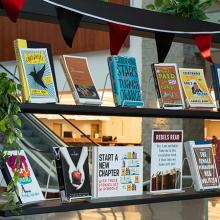 Bookshelf with various books on display in the library.