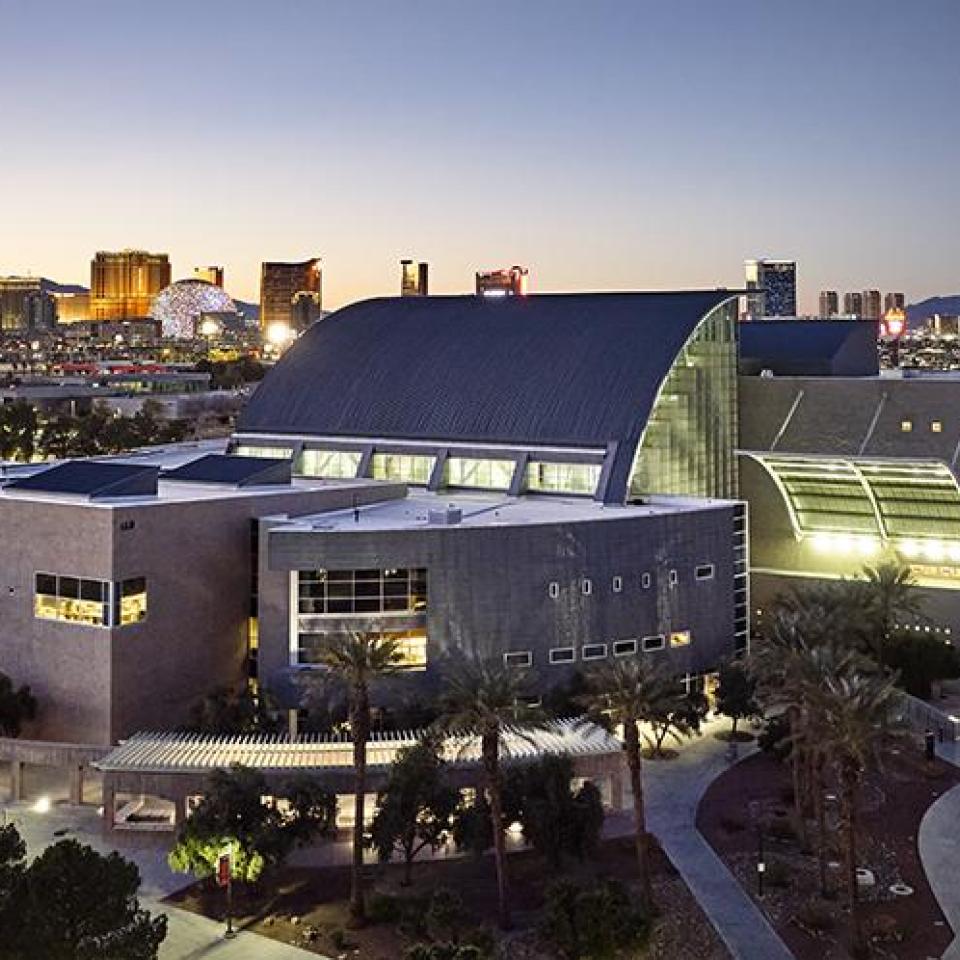 Aeriel view of Lied Library at dusk and the Las Vegas skyline in the background.