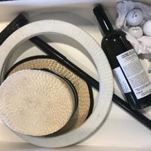 Archival box with objects such as hat, bottle, and golf balls