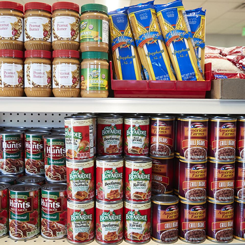 Stacks of canned food on the shelves at the UNLV Food Pantry.