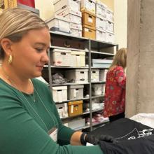 Researcher handling an artifact in a special collections and archives room.