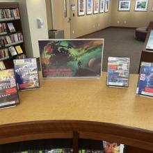 Science Fiction themed books and movies display on a shelf